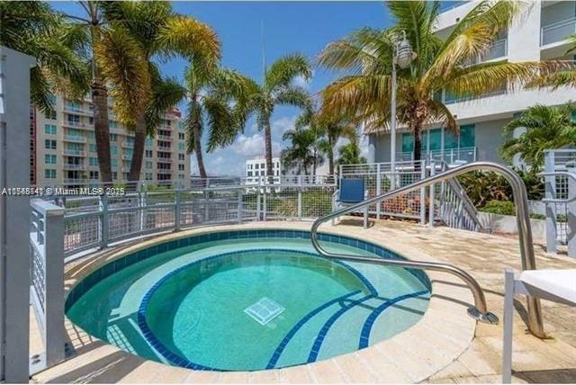 view of swimming pool with a patio area and a community hot tub