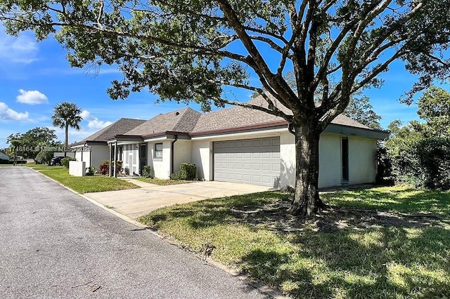 view of front facade with a front yard and a garage