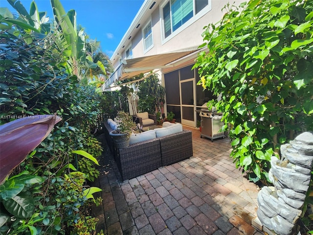 view of patio featuring outdoor lounge area and a sunroom