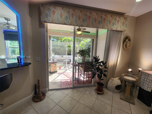 interior space with tile patterned floors and ceiling fan