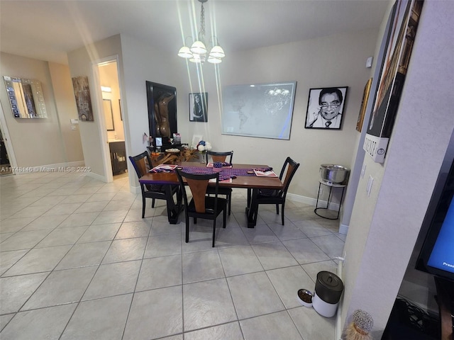 tiled dining space featuring a chandelier