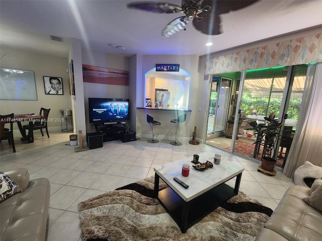 living room with tile patterned floors and ceiling fan