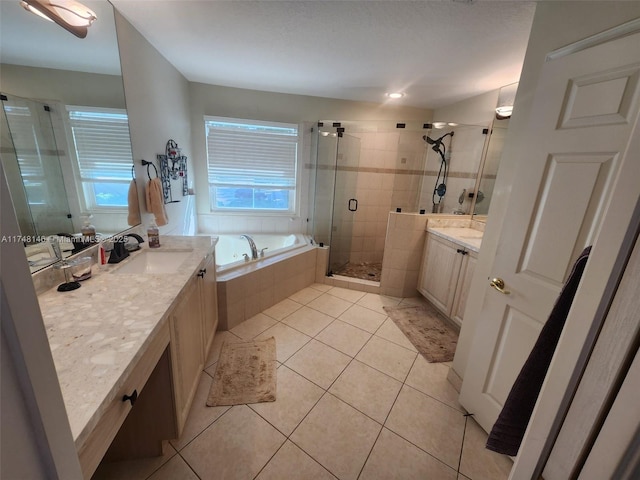 bathroom with plus walk in shower, vanity, and tile patterned flooring