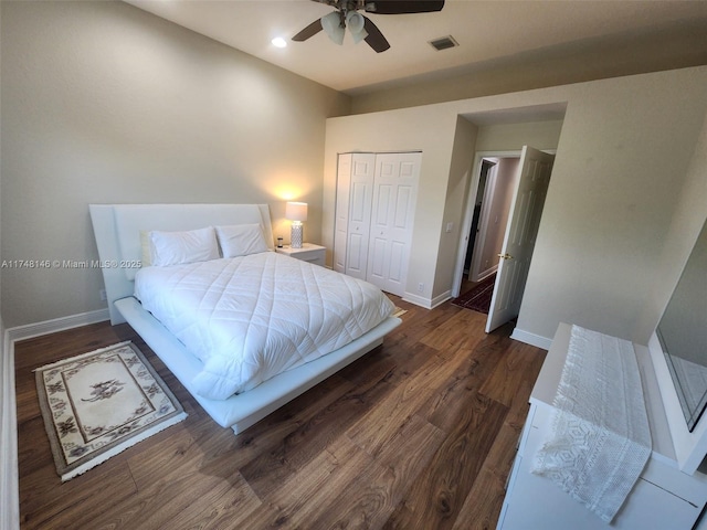 bedroom with ceiling fan, a closet, and dark wood-type flooring