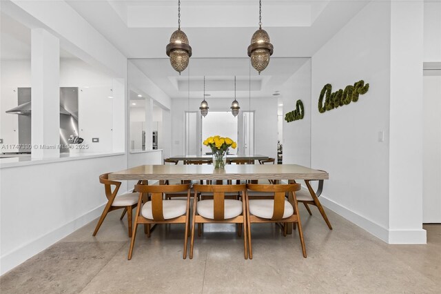 211 Water Way Unit 211, Miami Beach, FL 33141 - dining room with a raised ceiling, baseboards, and finished concrete floors