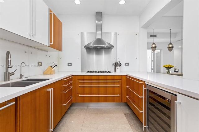 211 Water Way Unit 211, Miami Beach, FL 33141 - kitchen featuring a sink, wall chimney exhaust hood, brown cabinets, and beverage cooler