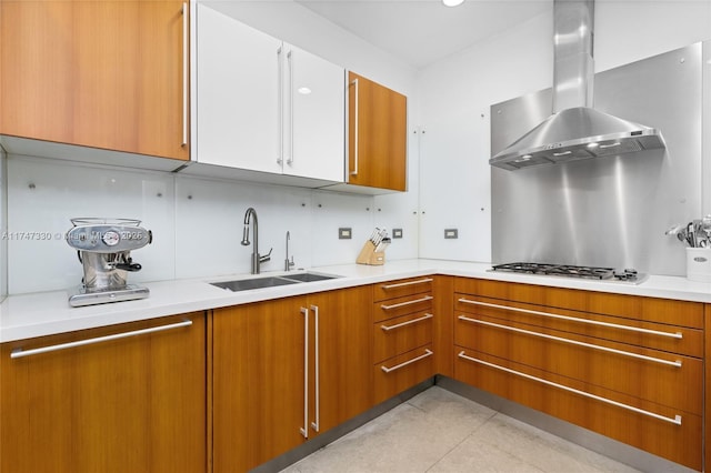 211 Water Way Unit 211, Miami Beach, FL 33141 - kitchen featuring light countertops, stainless steel gas cooktop, range hood, a sink, and brown cabinets