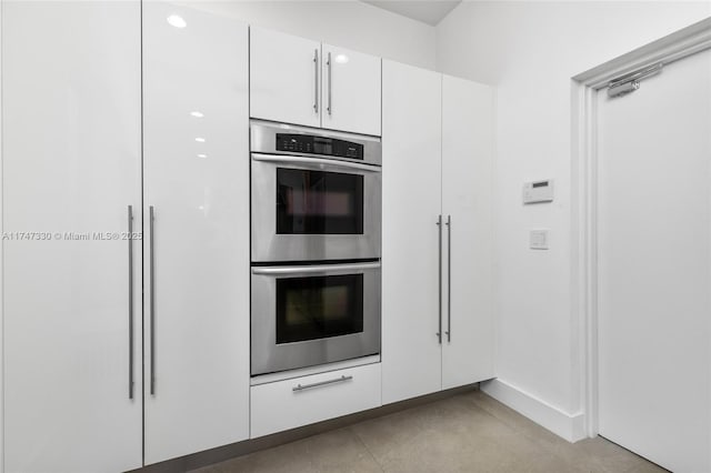 211 Water Way Unit 211, Miami Beach, FL 33141 - kitchen with double oven and white cabinets