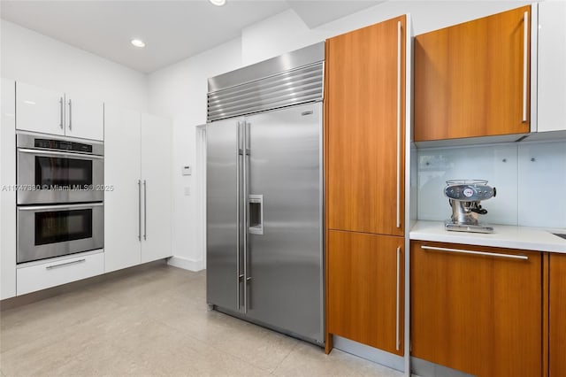 211 Water Way Unit 211, Miami Beach, FL 33141 - kitchen featuring light countertops, modern cabinets, brown cabinets, recessed lighting, and appliances with stainless steel finishes