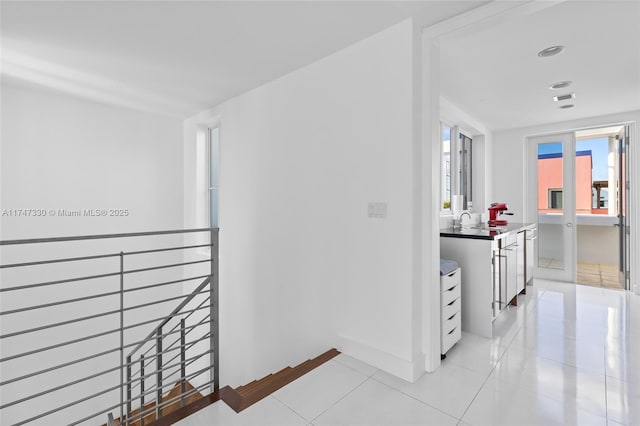 211 Water Way Unit 211, Miami Beach, FL 33141 - corridor with light tile patterned floors, a sink, and baseboards