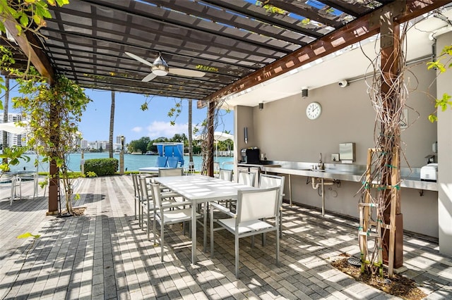 211 Water Way Unit 211, Miami Beach, FL 33141 - view of patio / terrace with a sink, a pergola, outdoor dining area, a water view, and ceiling fan