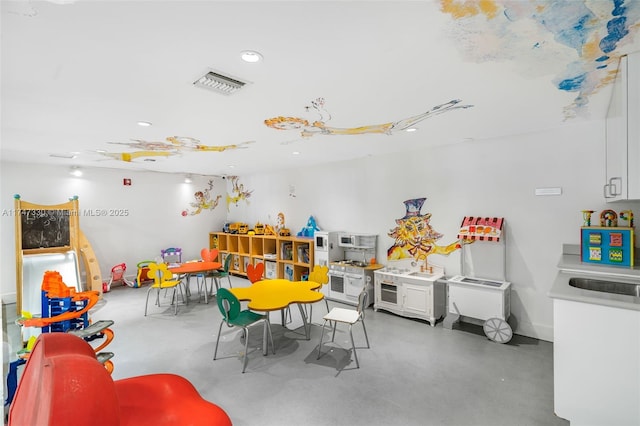 211 Water Way Unit 211, Miami Beach, FL 33141 - playroom featuring finished concrete flooring and visible vents