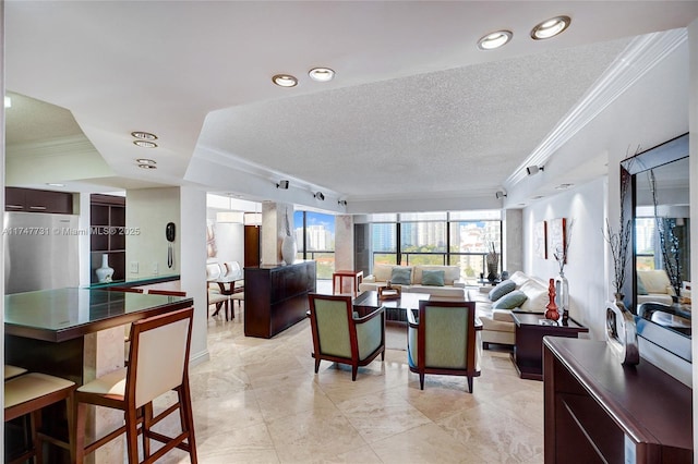 living room featuring a textured ceiling and crown molding