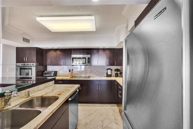 kitchen featuring dark brown cabinets, appliances with stainless steel finishes, a sink, and visible vents