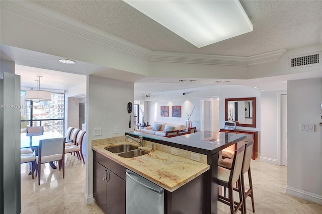 kitchen featuring a textured ceiling, visible vents, dishwasher, a sink, and open floor plan