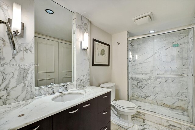 19667 Turnberry Way Unit 12F, Aventura, FL 33180 - full bathroom with vanity, marble finish floor, toilet, recessed lighting, and a marble finish shower