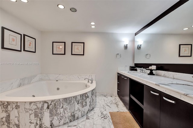 full bathroom with double vanity, a sink, marble finish floor, and a jetted tub