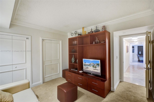 living room with crown molding, baseboards, light carpet, and a textured ceiling