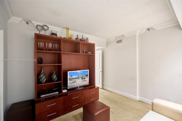 living room featuring light colored carpet, ornamental molding, a textured ceiling, and visible vents