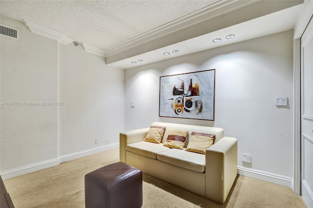 carpeted living area with visible vents, ornamental molding, a textured ceiling, and baseboards