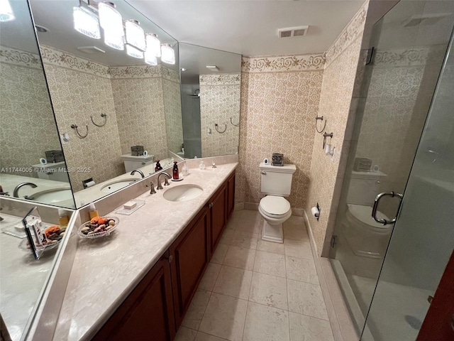 bathroom with tile patterned floors, a shower with shower door, toilet, and vanity