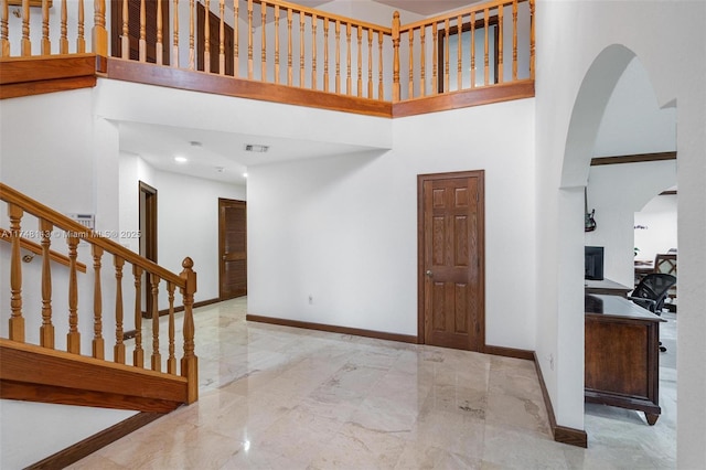 kitchen featuring appliances with stainless steel finishes, a sink, light stone counters, and crown molding