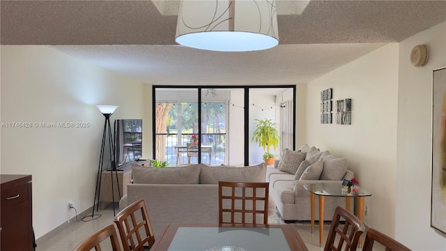 dining space with floor to ceiling windows and a textured ceiling