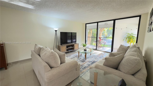 living room featuring a wall of windows, a textured ceiling, and light tile patterned floors