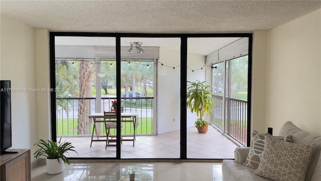 doorway featuring a textured ceiling, tile patterned flooring, and expansive windows