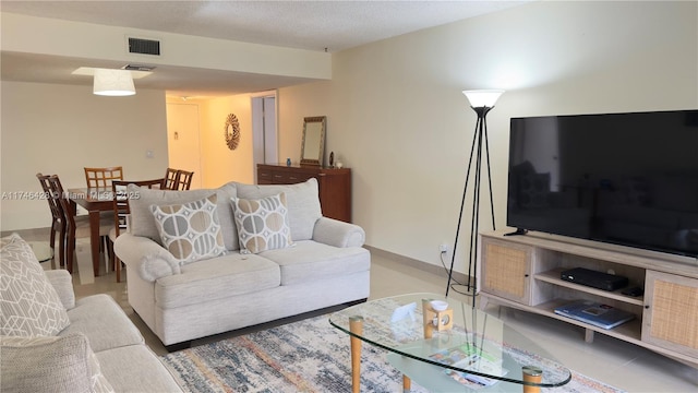 living area featuring visible vents and baseboards