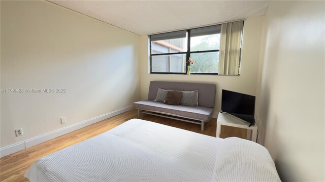 16475 Golf Club Rd Unit 202, Weston, FL 33326 - bedroom featuring baseboards and wood finished floors