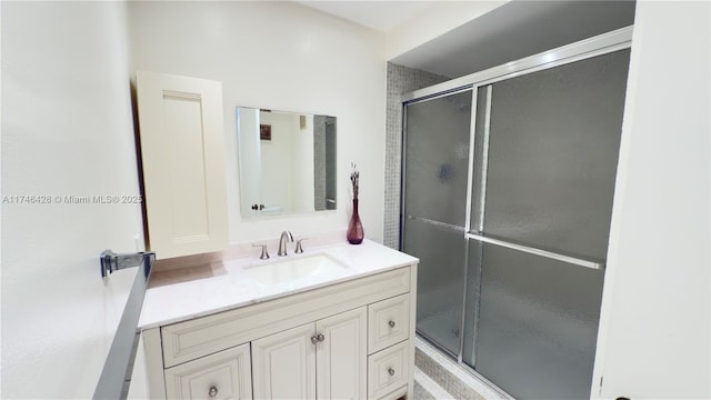 bathroom featuring vanity and a shower with shower door