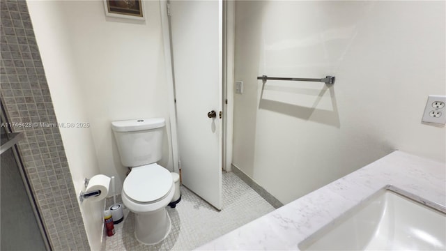 bathroom with vanity, tile patterned flooring, and toilet