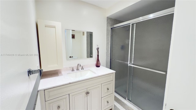 full bathroom with a stall shower and vanity