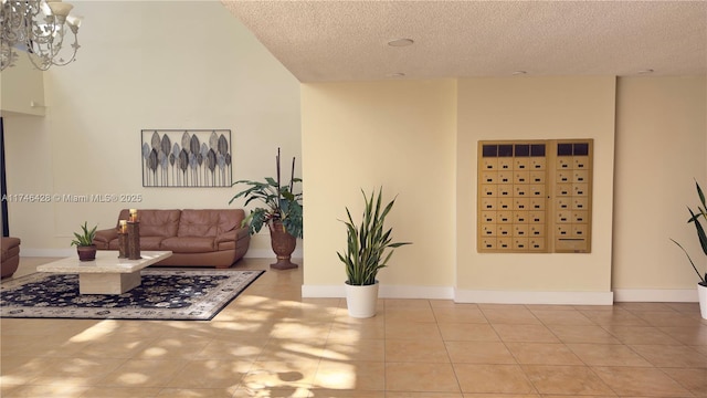 tiled living room with a textured ceiling and baseboards
