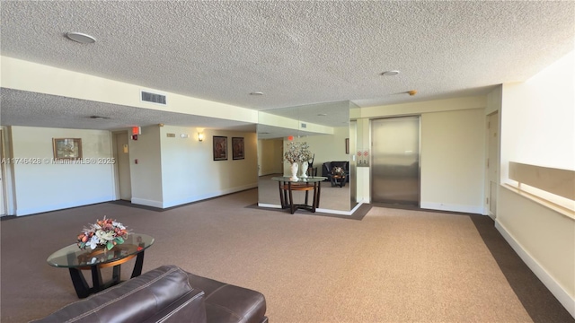 carpeted living room with elevator, visible vents, a textured ceiling, and baseboards