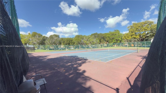 view of sport court featuring fence