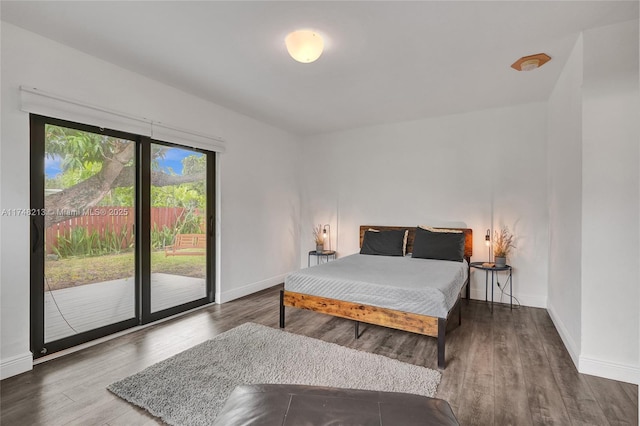 bedroom with access to outside and dark hardwood / wood-style floors