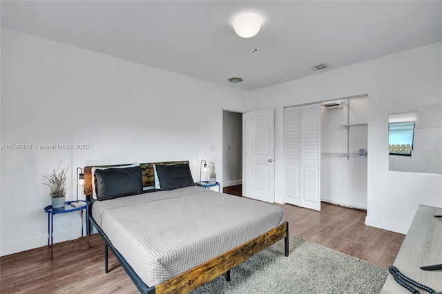 bedroom featuring a closet and dark hardwood / wood-style floors