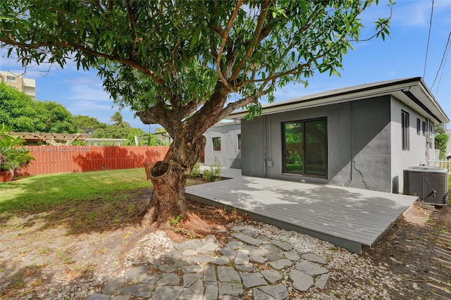 rear view of house with a yard and cooling unit