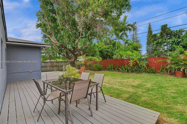 wooden terrace featuring a yard