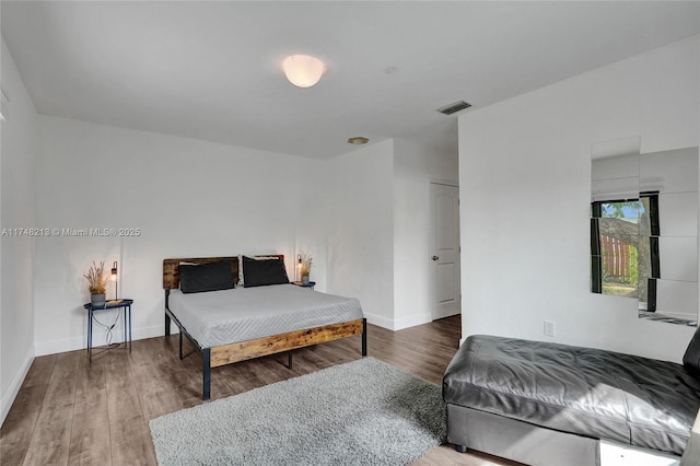 bedroom with hardwood / wood-style flooring