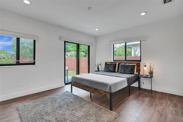 bedroom with dark wood-type flooring and access to outside