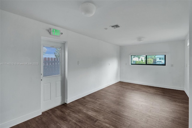 unfurnished room featuring dark hardwood / wood-style flooring