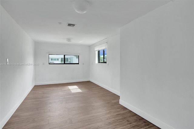 empty room with hardwood / wood-style flooring