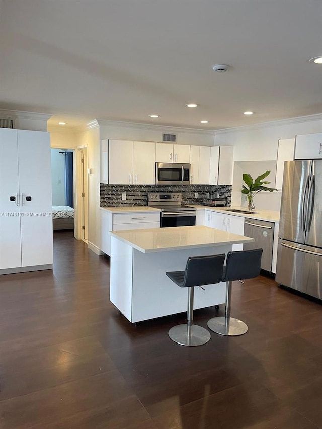 4721 W Park Rd, Hollywood, FL 33021 - kitchen featuring stainless steel appliances, light countertops, ornamental molding, white cabinets, and recessed lighting