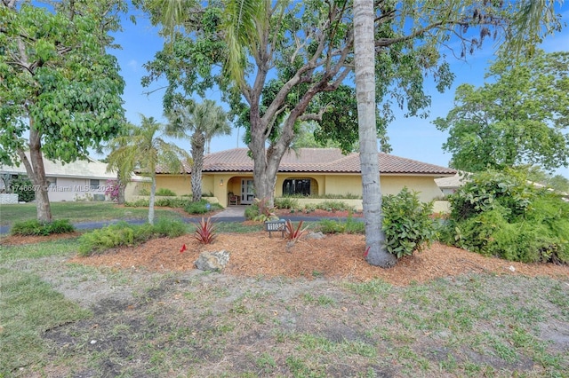 view of front of house with a tiled roof and stucco siding