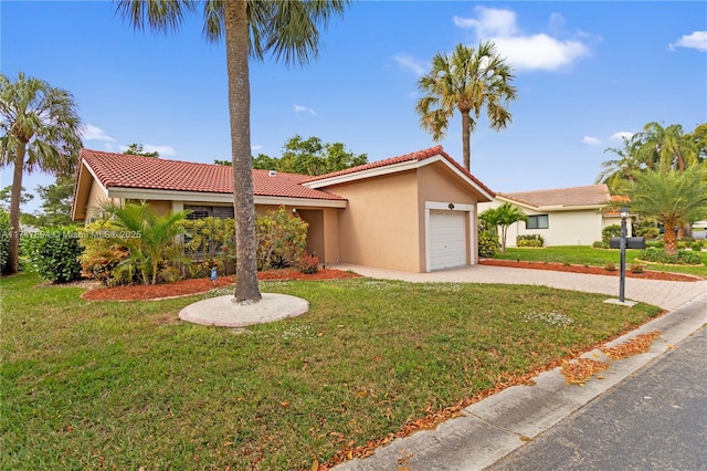 view of front of home with a front lawn and a garage