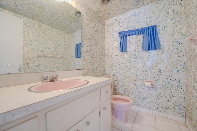 bathroom with tile patterned floors, vanity, and toilet