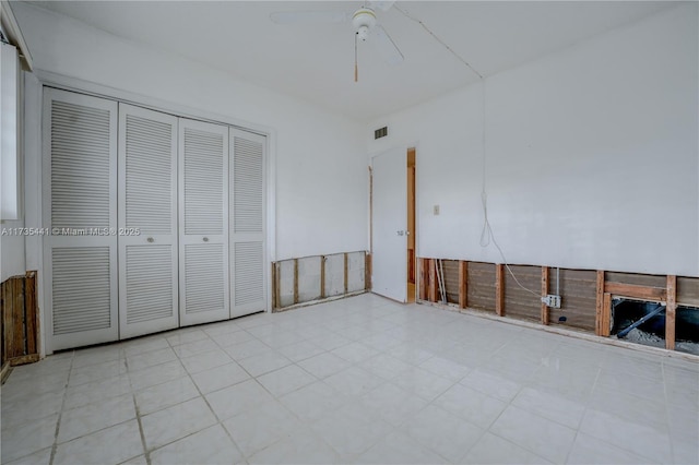 unfurnished bedroom with a closet and ceiling fan